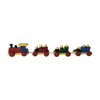 Small vintage multi-coloured wooden train with locomotive and 3 cars