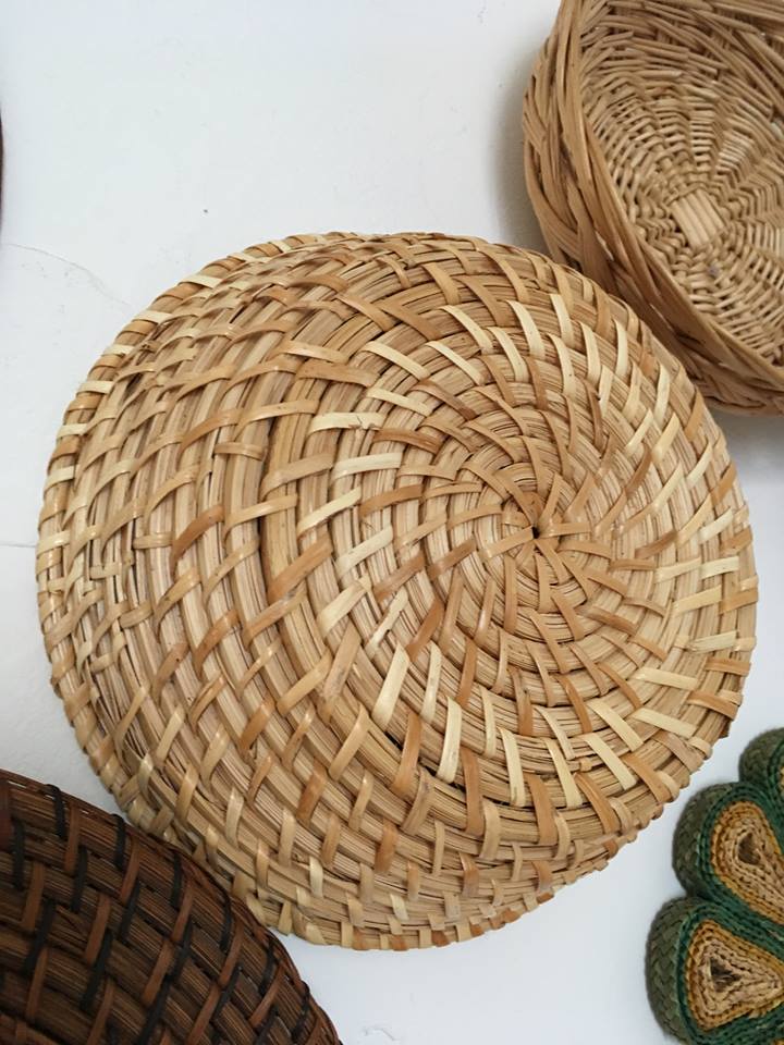 Wall composition of seven baskets and wicker trays.