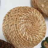 Wall composition of seven baskets and wicker trays.