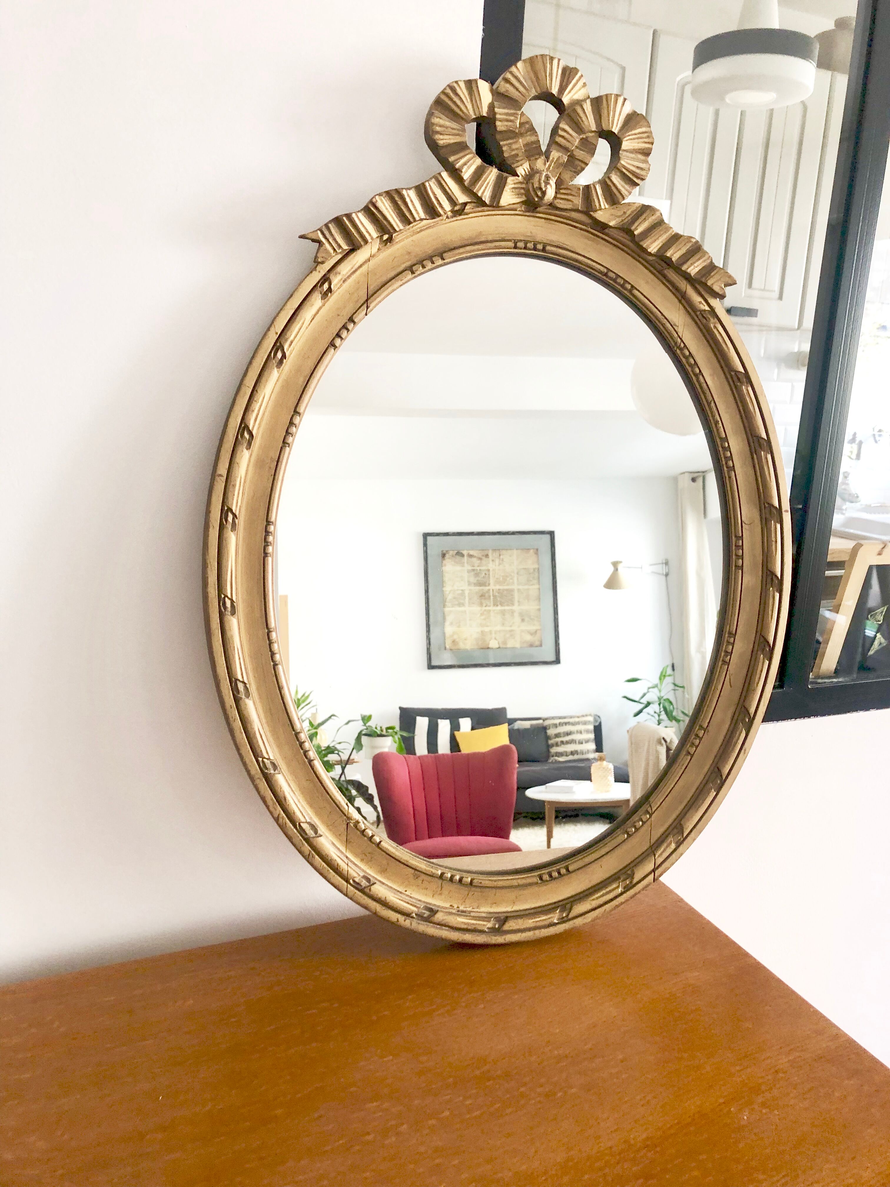 Old oval mirror with a pediment