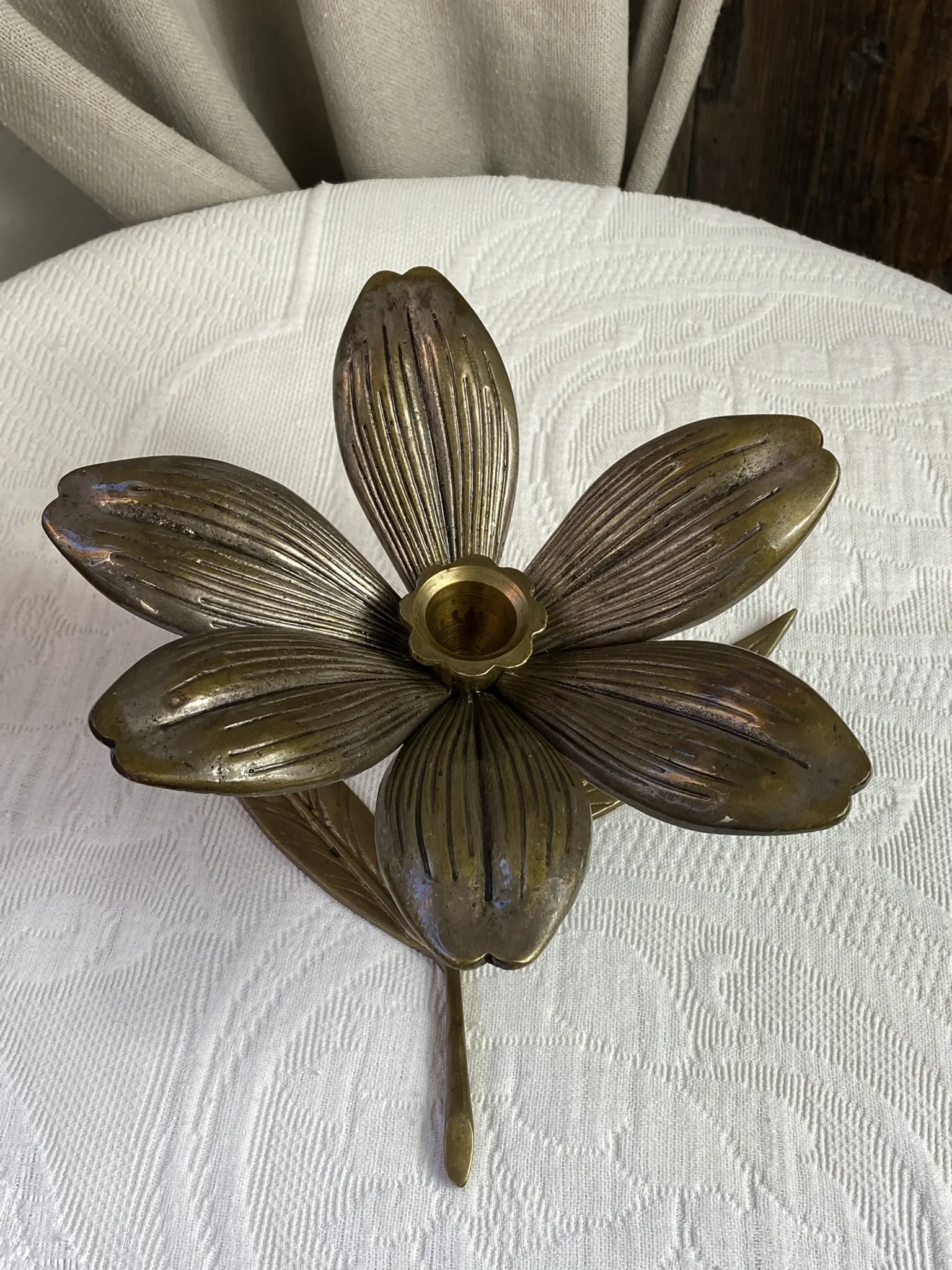 Flower candlestick and removable ashtrays in solid brass.
