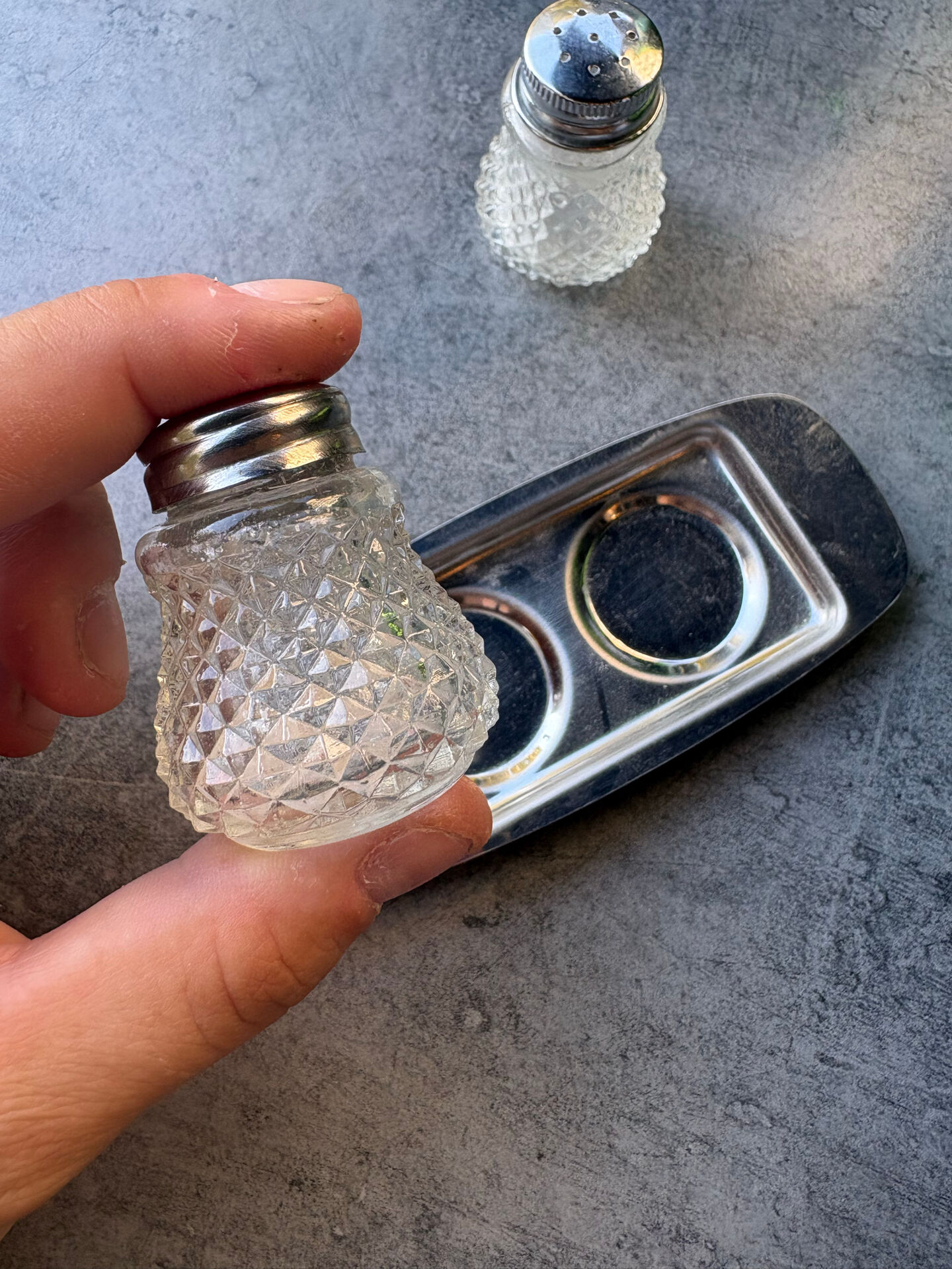 Vintage glass and chrome salt and pepper shaker set.