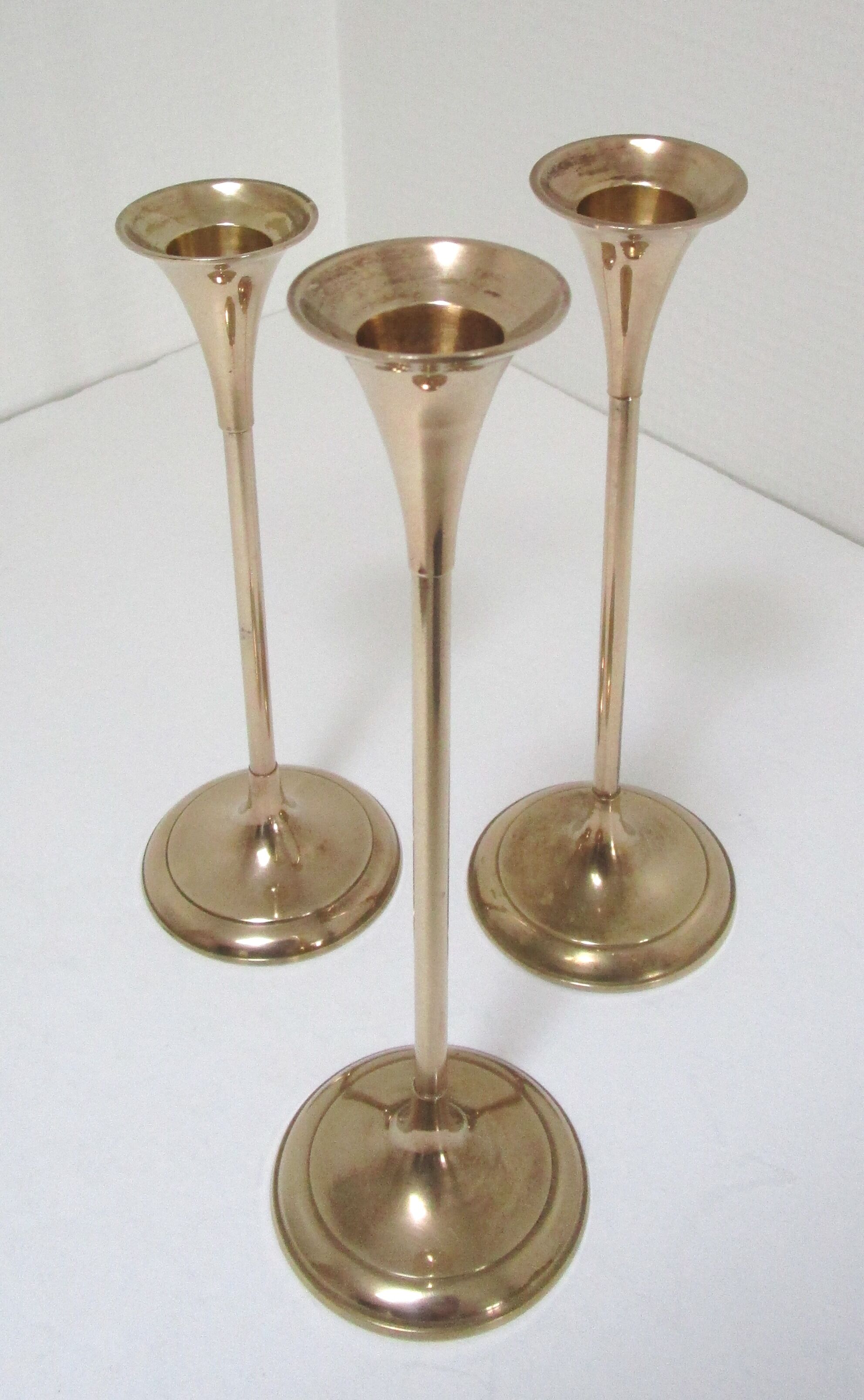 Trio of brass scandinavian candlesticks