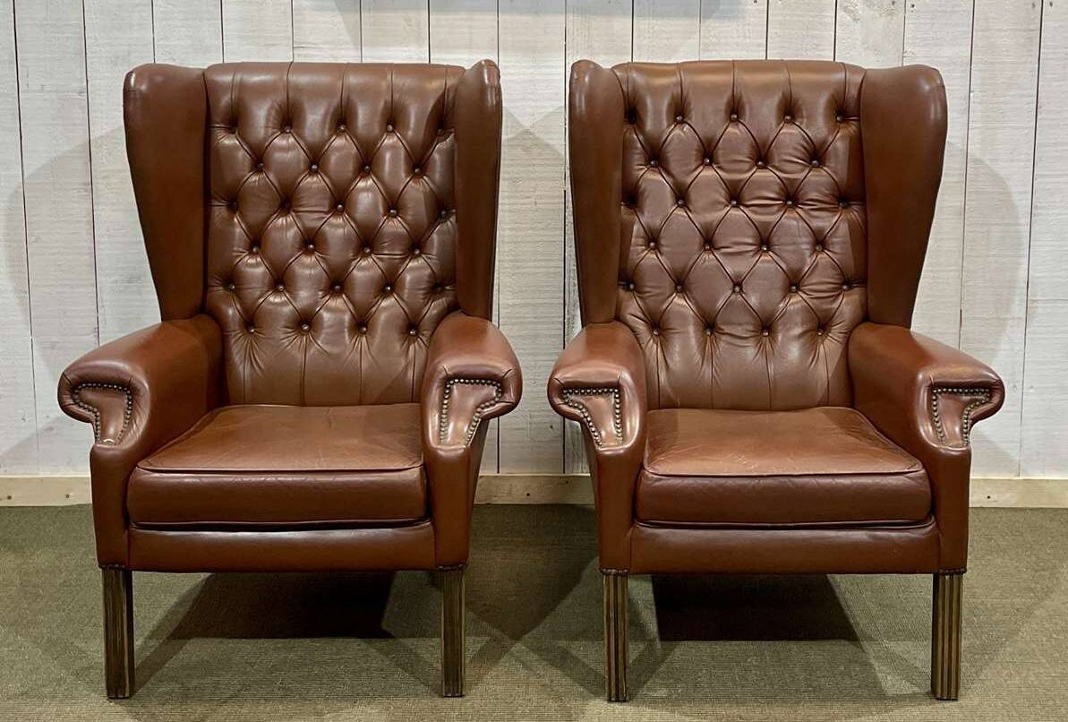 Pair of brown leather wingback Chesterfield armchairs from the 1970s.
