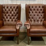 Pair of brown leather wingback Chesterfield armchairs from the 1970s.