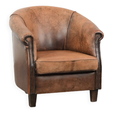 Vintage sheepskin club armchair with character and a beautiful patina