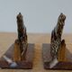 Small roaring lion bookends in patinated metal on a marble base.
