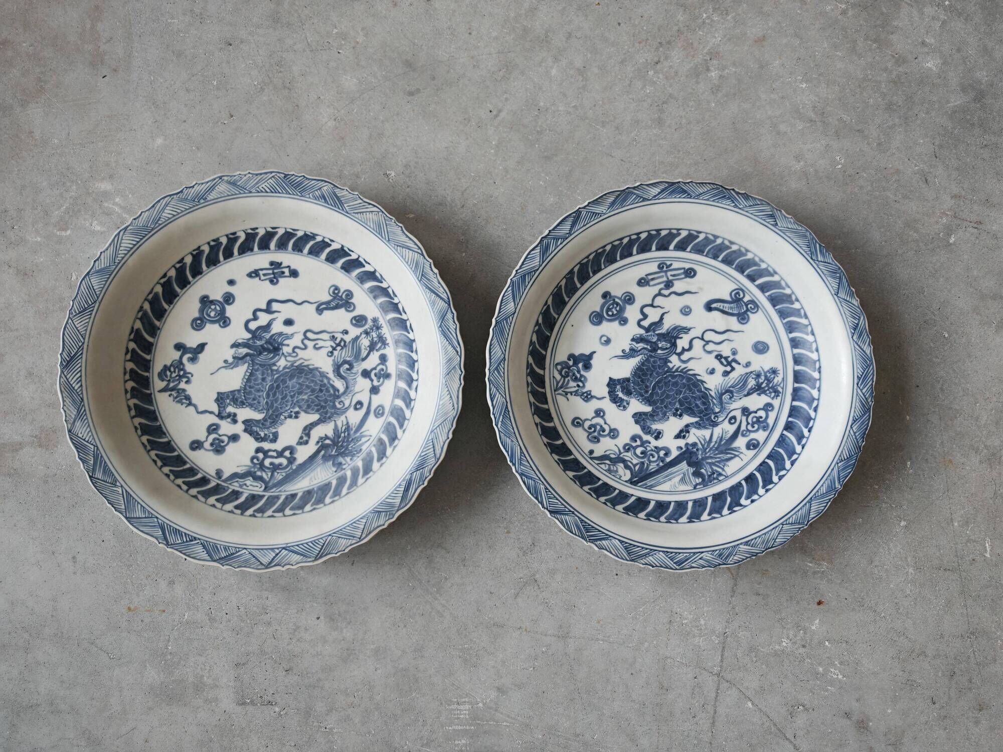 Pair of antique Chinese decorative plates with dragon motif.