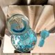 Turquoise blue liquor decanter and glass gild mold press of the 1950s