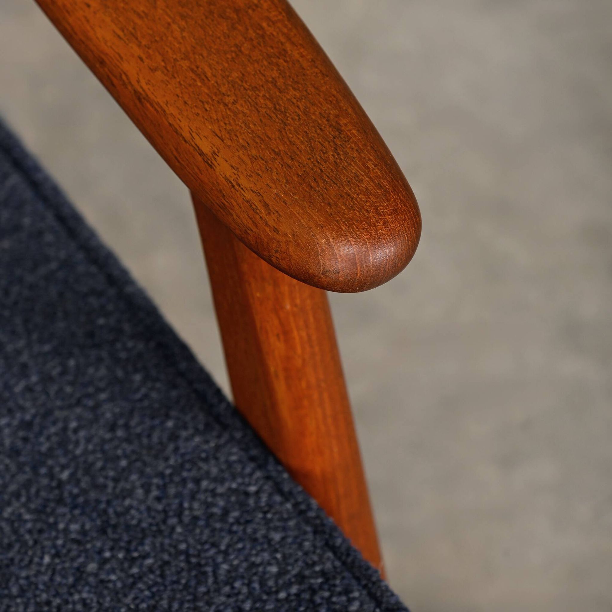 Pair Scandinavian Modern armchairs in teak and dark blue bouclé fabric