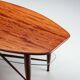 Assymetrical coffeetable with glass storage and cross leg details