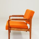 Vintage armchair in papaya orange wool from the 1960s.