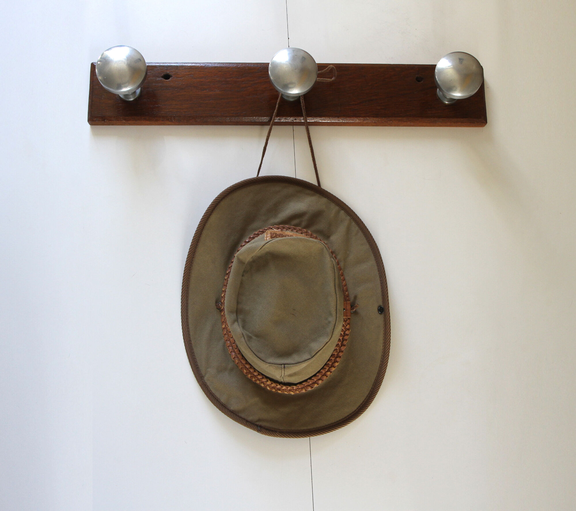 Wooden and stainless steel coat holders from the 1920s
