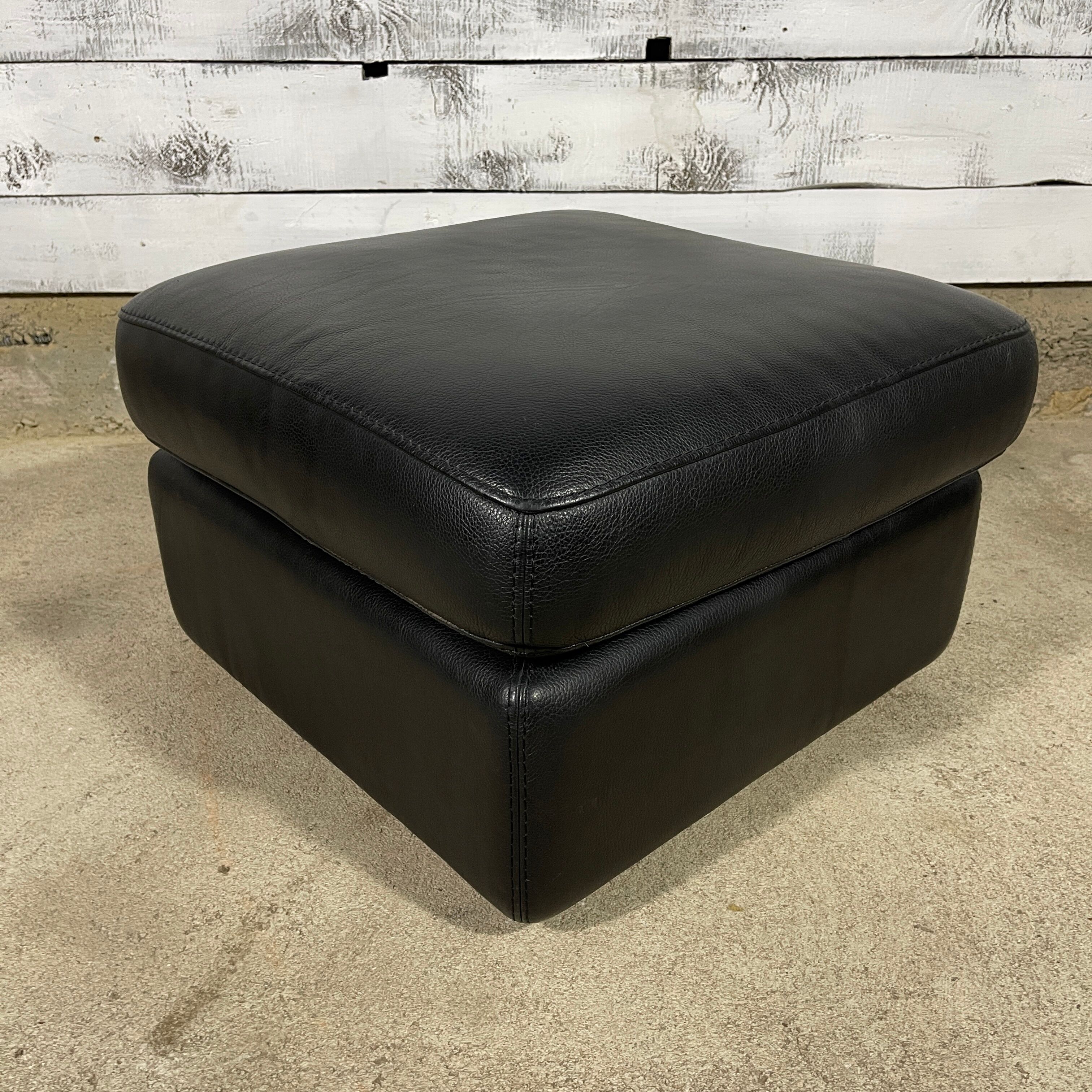Black leather pouf
