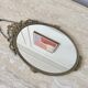 Oval mirror in gilded brass