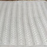 White two-seater crocheted bed top