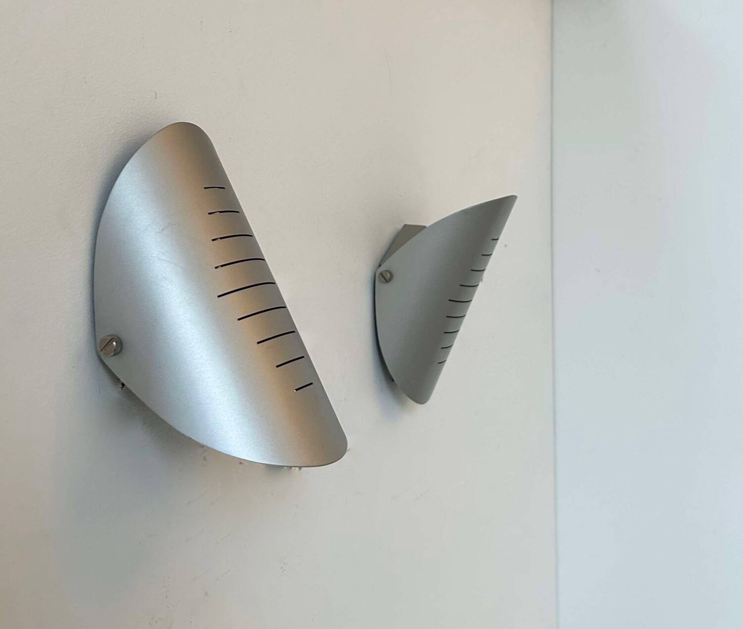 Pair of vintage adjustable wall lights, curved striated metal, France 1980