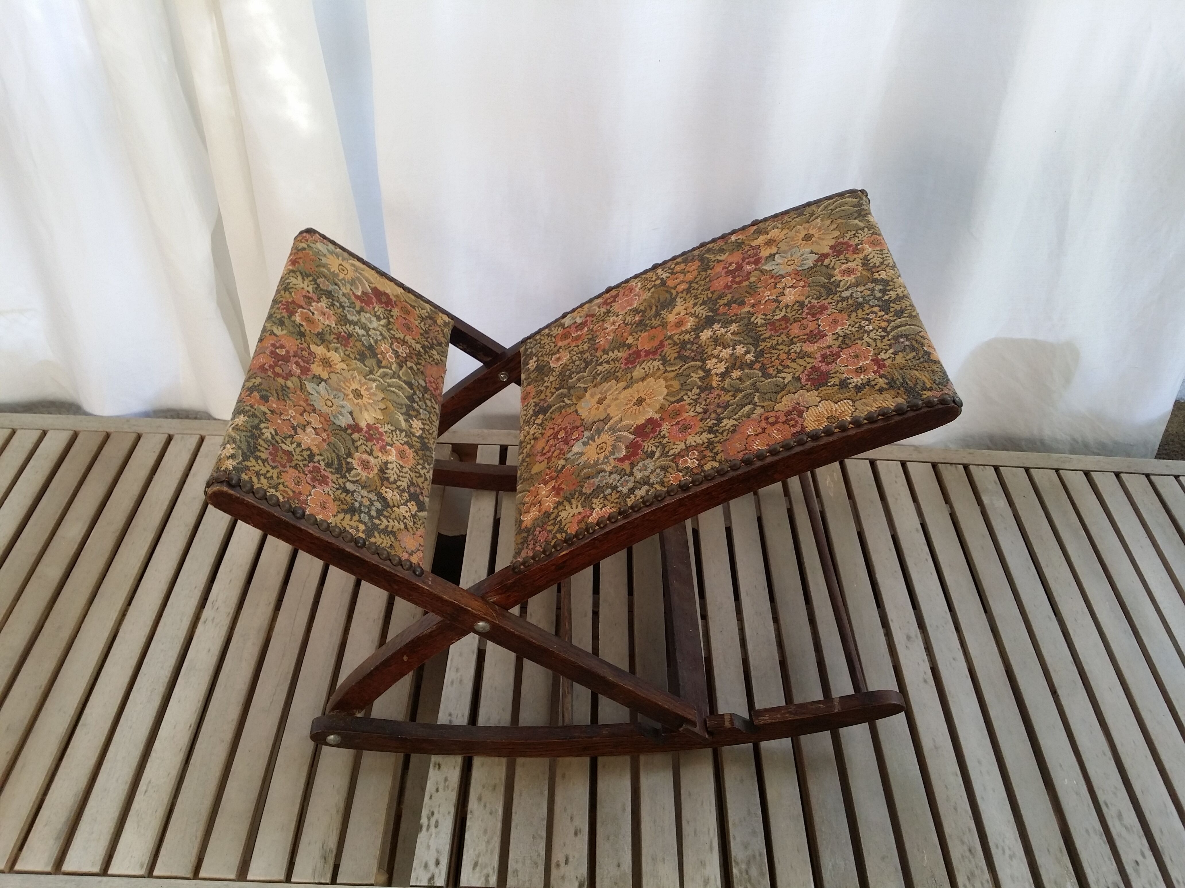 Wooden footrest and vintage tapestry