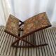 Wooden footrest and vintage tapestry