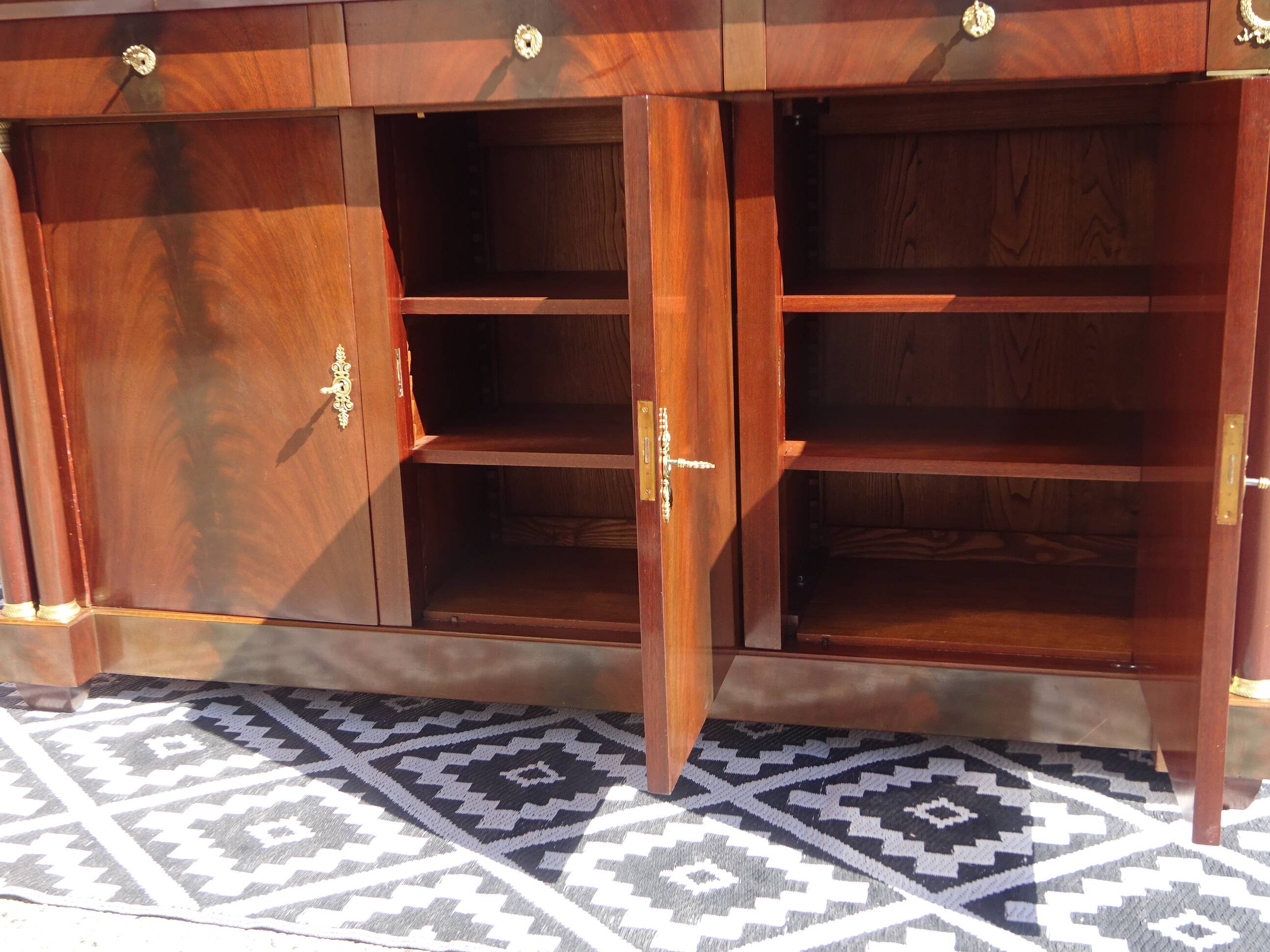 Flamed mahogany enfilade with sea green marble in Empire style.