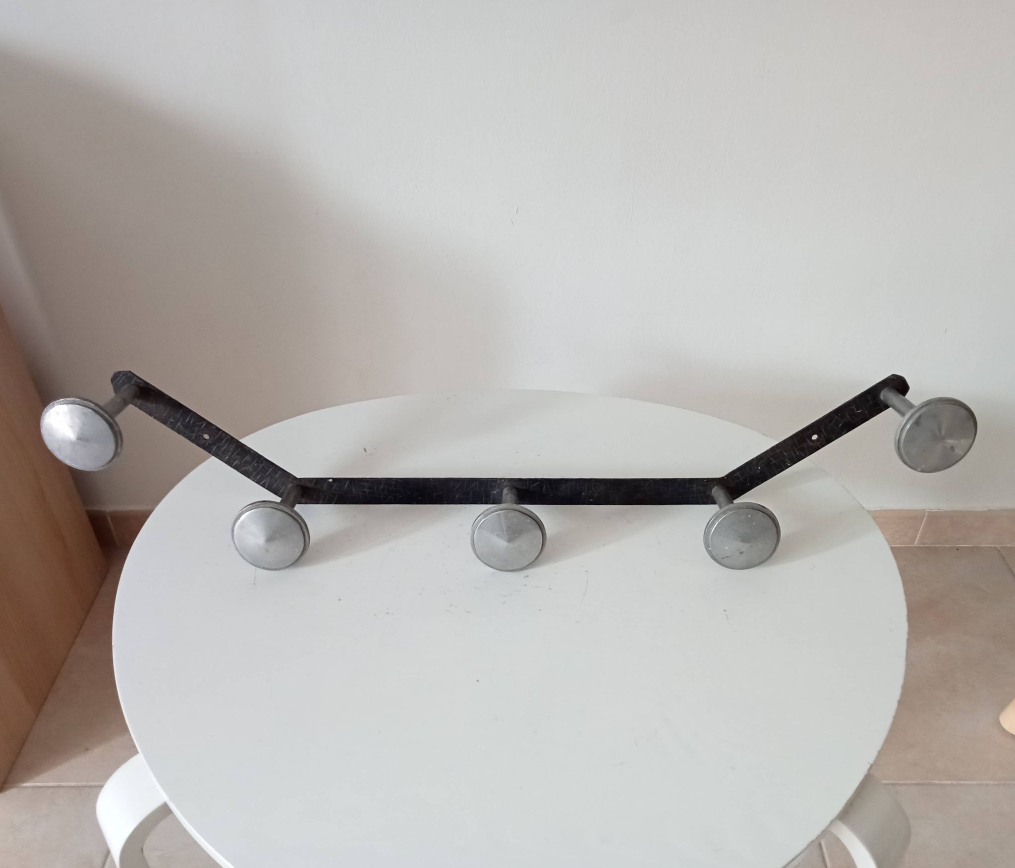 Vintage 1950s wall coat rack, wrought iron with chiselled details and solid aluminium.