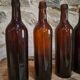 Set of 10 bottles of old Bordeaux French wine in ruby brown glass, 19th century.