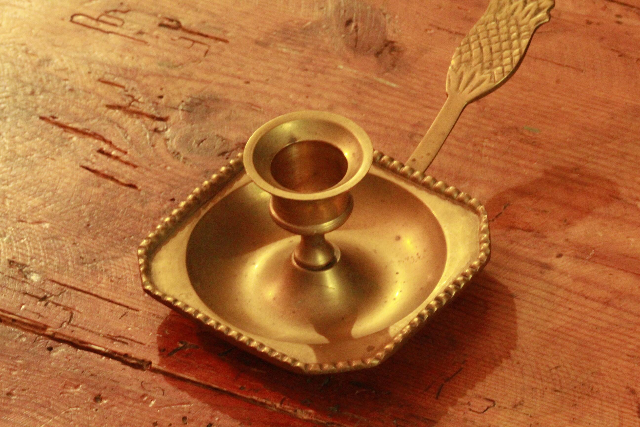 Old brass hand candle holder