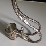 Large decanter with large glass neck and silver metal handle.