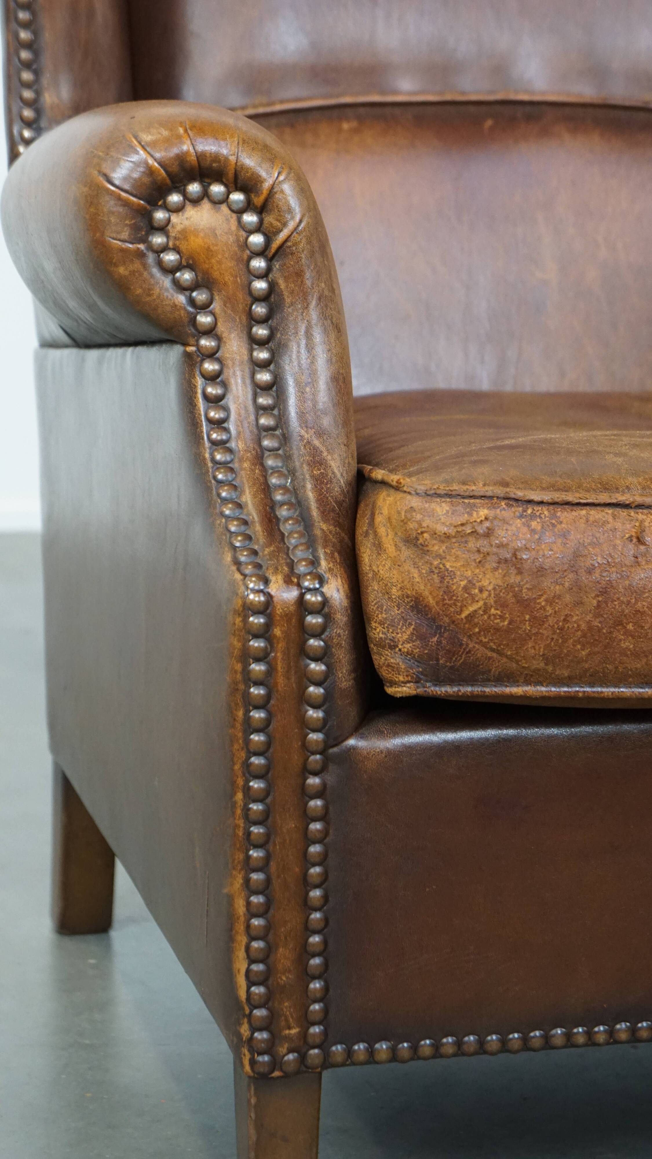 Cognac-colored sheepskin wing chair in English style