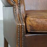 Cognac-colored sheepskin wing chair in English style