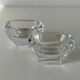 Pair of colourless crystal salt shakers from the Daum Nancy house.