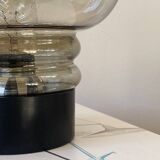 Sciolari table lamp with smoked glass globe and black plastic base.