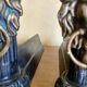 Pair of antique fire dogs with lion heads - patinated cast iron