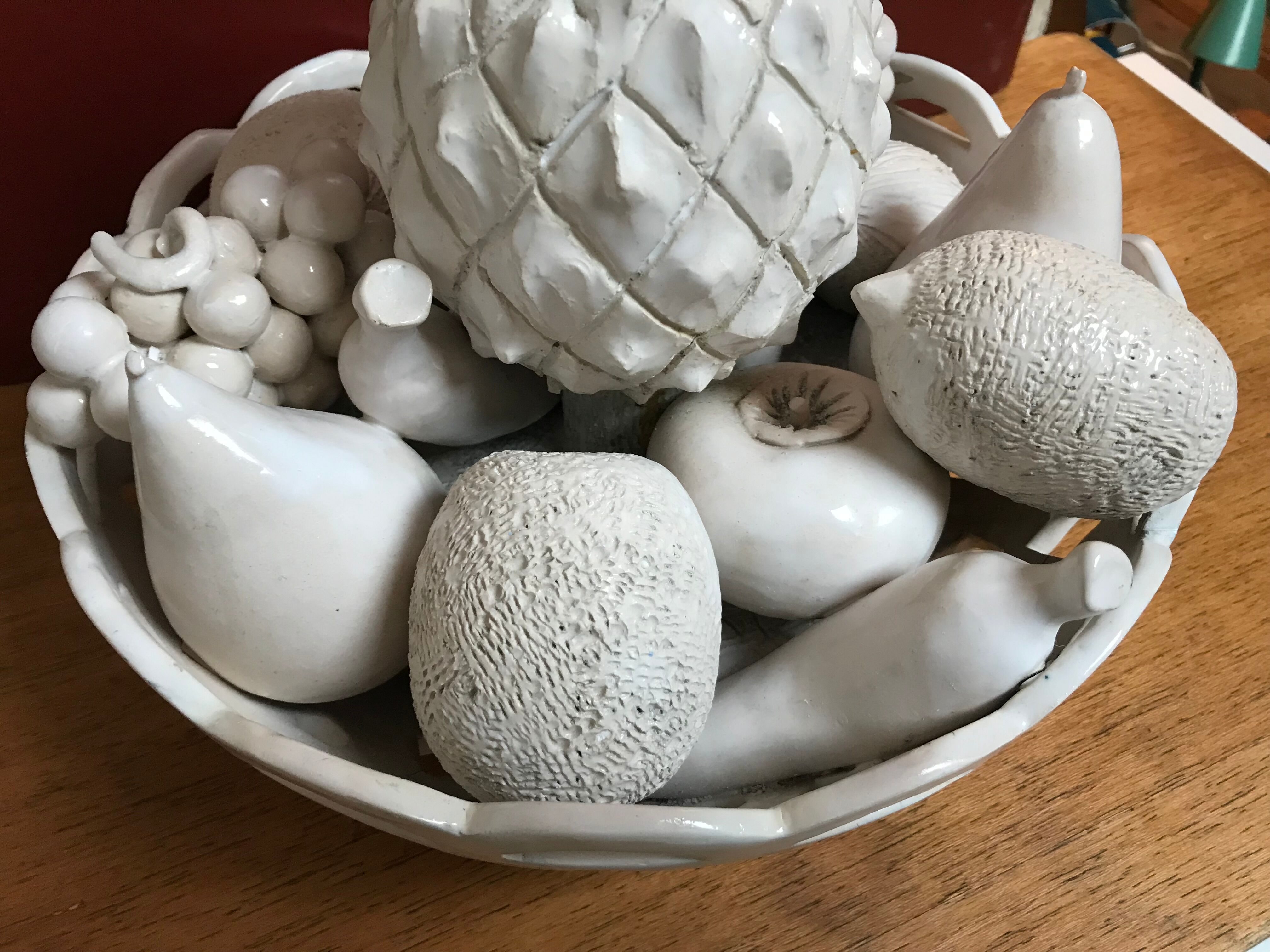 Trompe l'oeil fruit cut in white earthenware by Jean Roger, circa 1960.