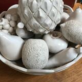 Trompe l'oeil fruit cut in white earthenware by Jean Roger, circa 1960.