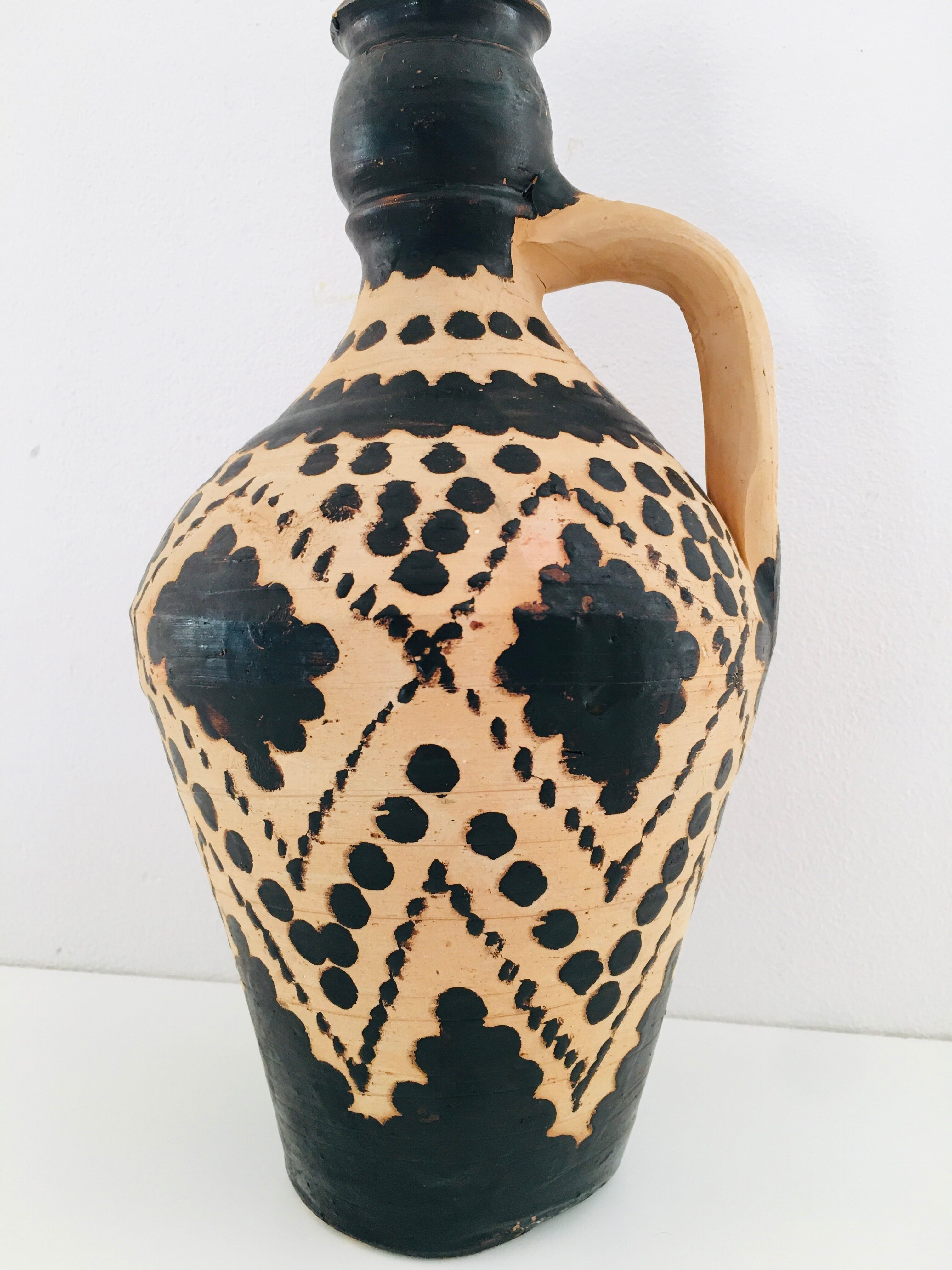 Raw and black terracotta jug