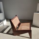 Reclined armchair in canned teak in natural wood