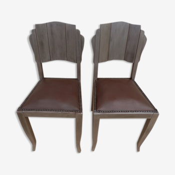 Two restyled leather-style chairs with nails