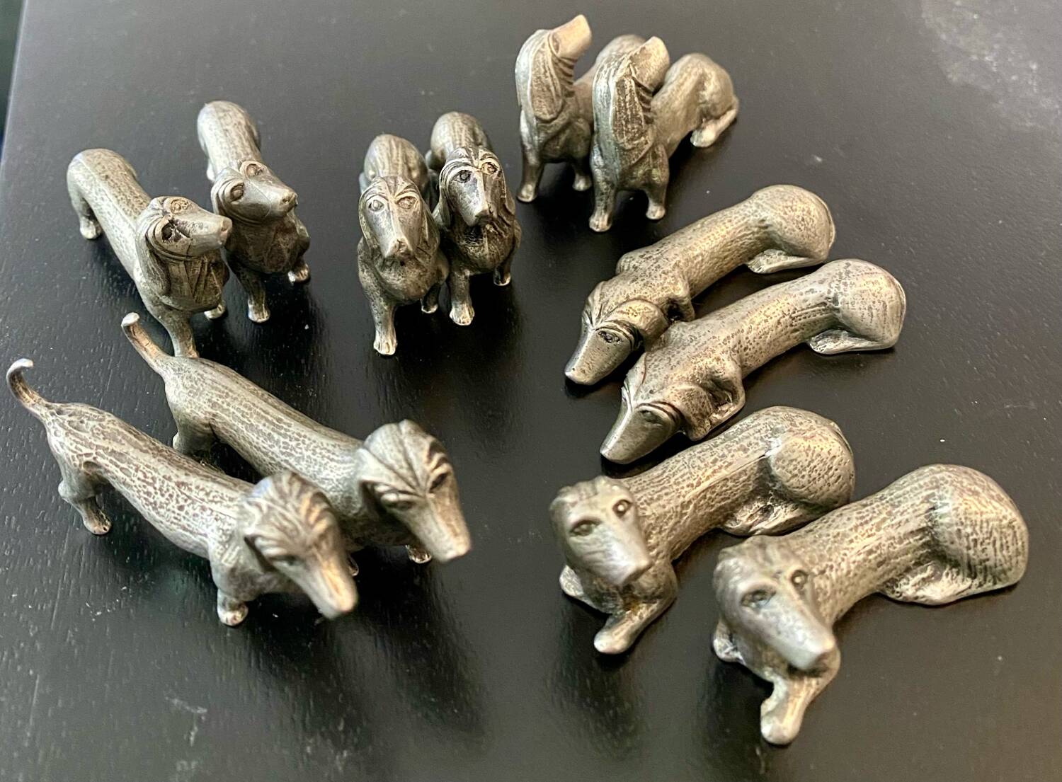 12 old dog-shaped Etains du Manoir knife holders