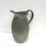 Art deco pitcher in hammered tin and signed E.H. Derbesy