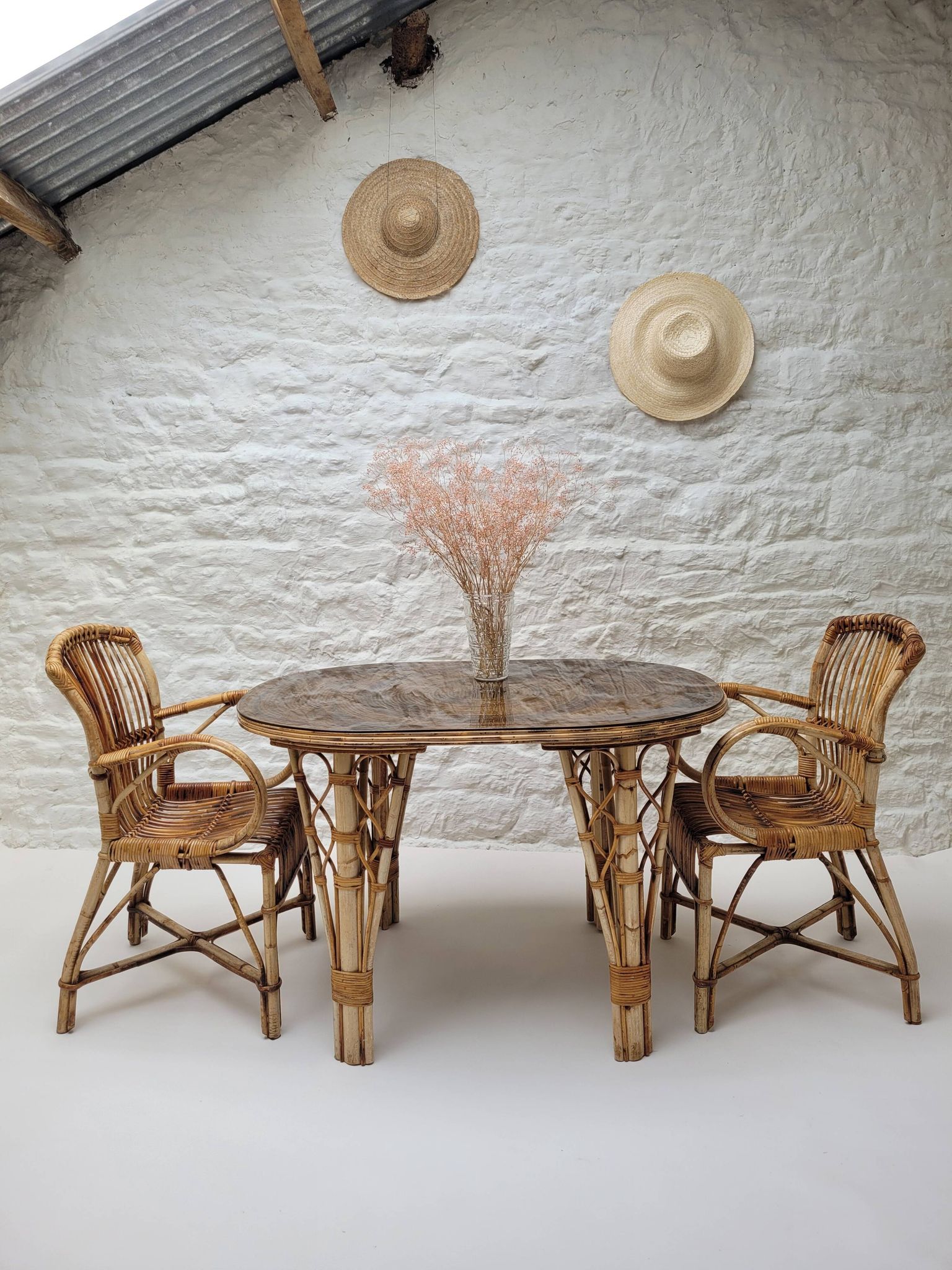 Vintage Audoux Minet bamboo, rattan, and smoked glass table duo.