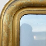 Large antique French gilded mirror with painted floral decoration.