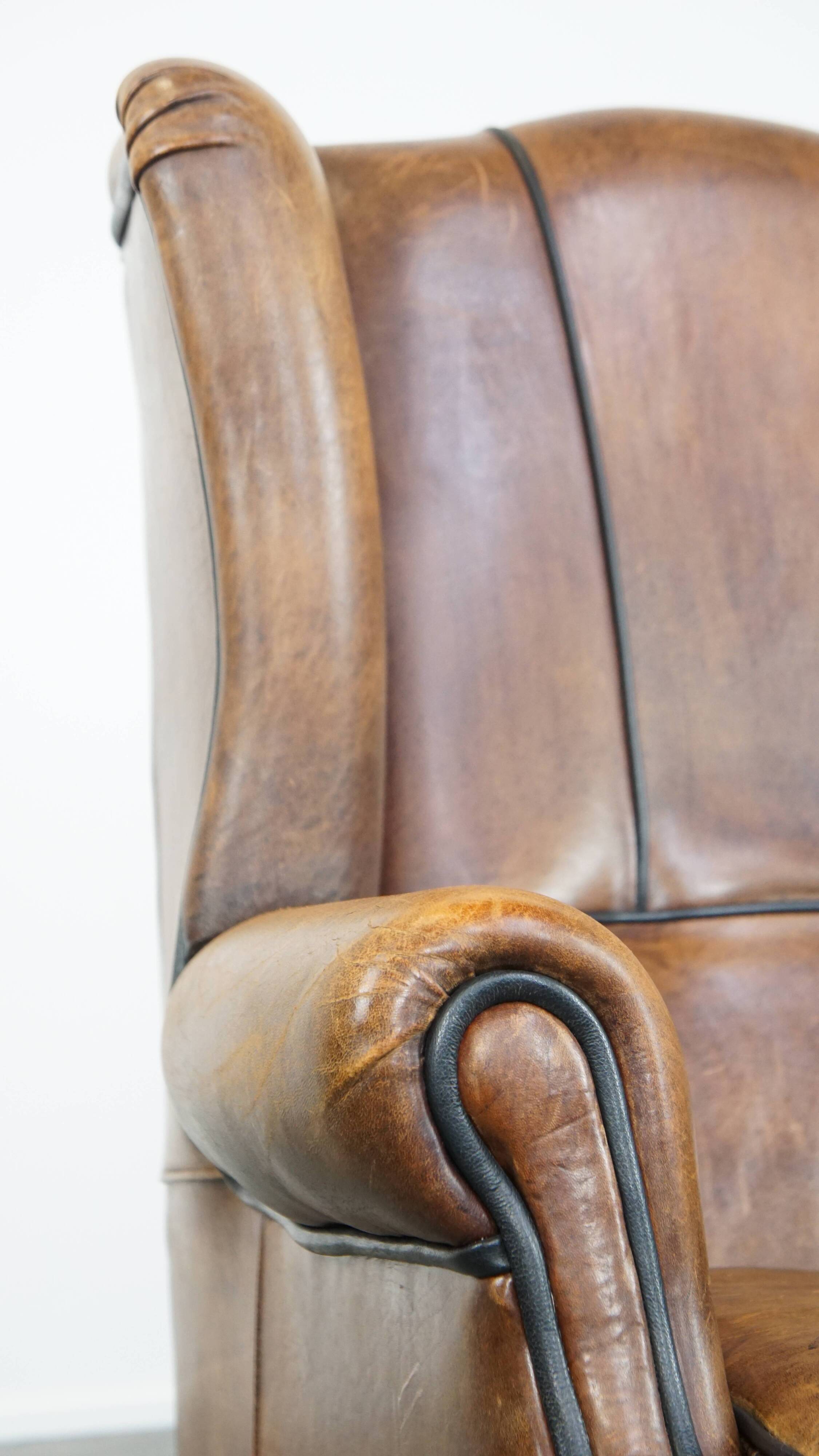 Sheep leather wingback chair finished with black piping