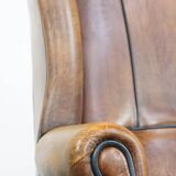 Sheep leather wingback chair finished with black piping