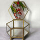 Glass box and hexagonal brass enamelled floral decoration