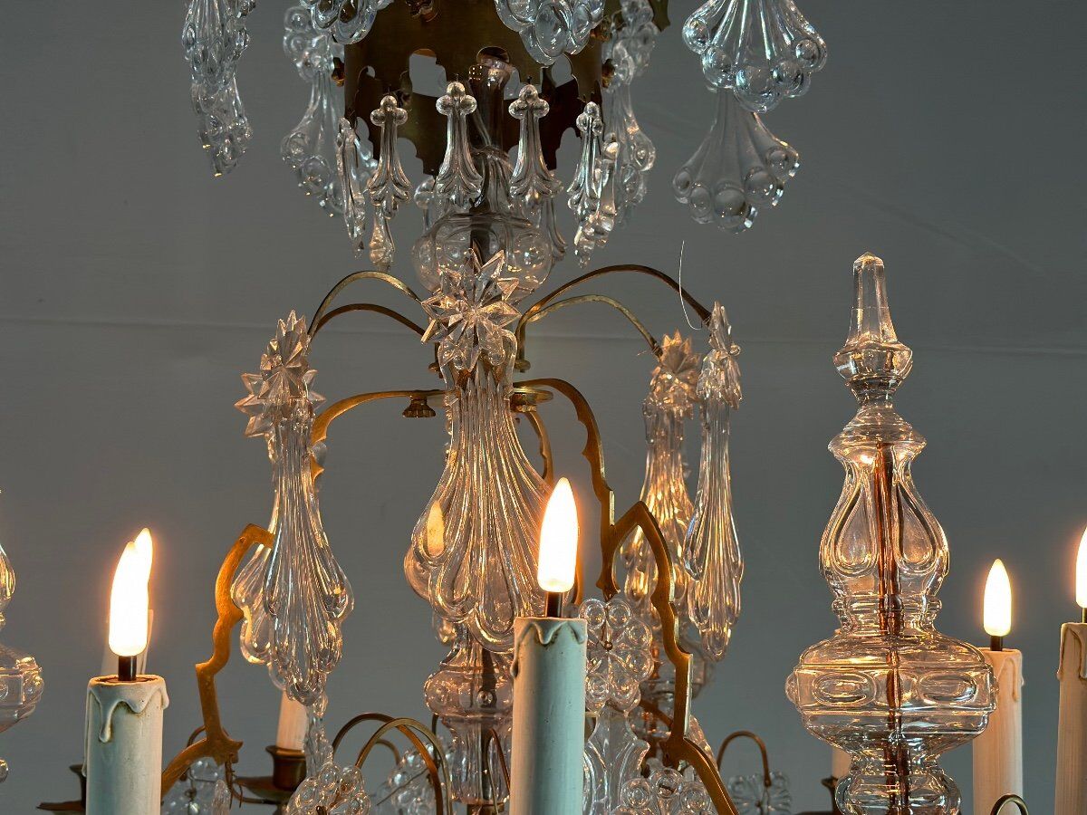 Bronze cage chandelier adorned with molded glass pendants in the shape of peacock feathers, circa 1800