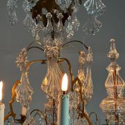 Bronze cage chandelier adorned with molded glass pendants in the shape of peacock feathers, circa 1800