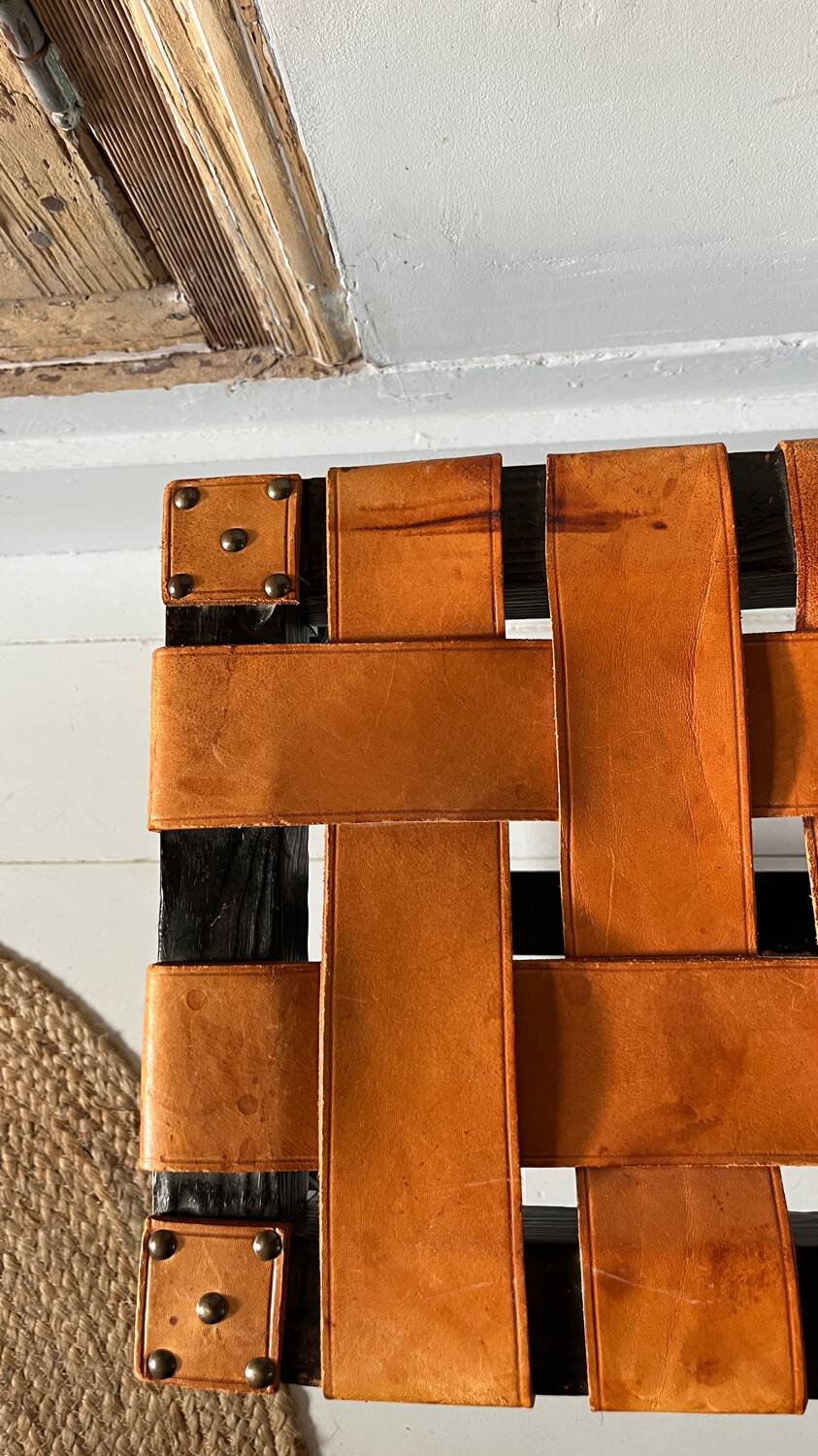 Antique turned wooden stool with woven leather.