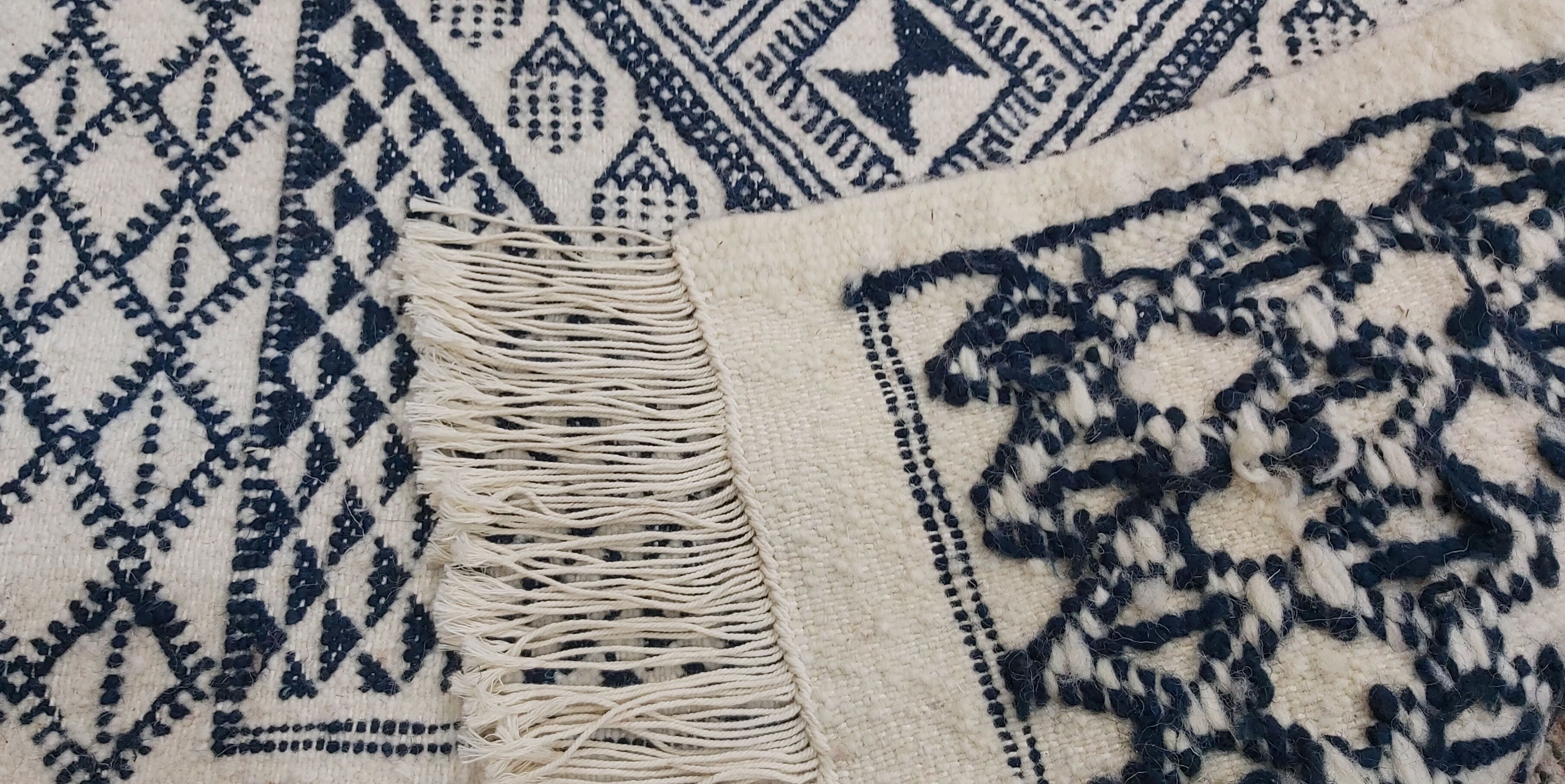 Traditional white and blue hand-woven wool carpet