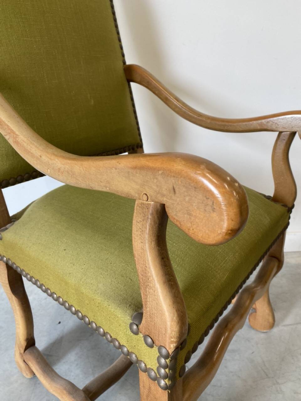 Olive green upholstered armchairs with studs